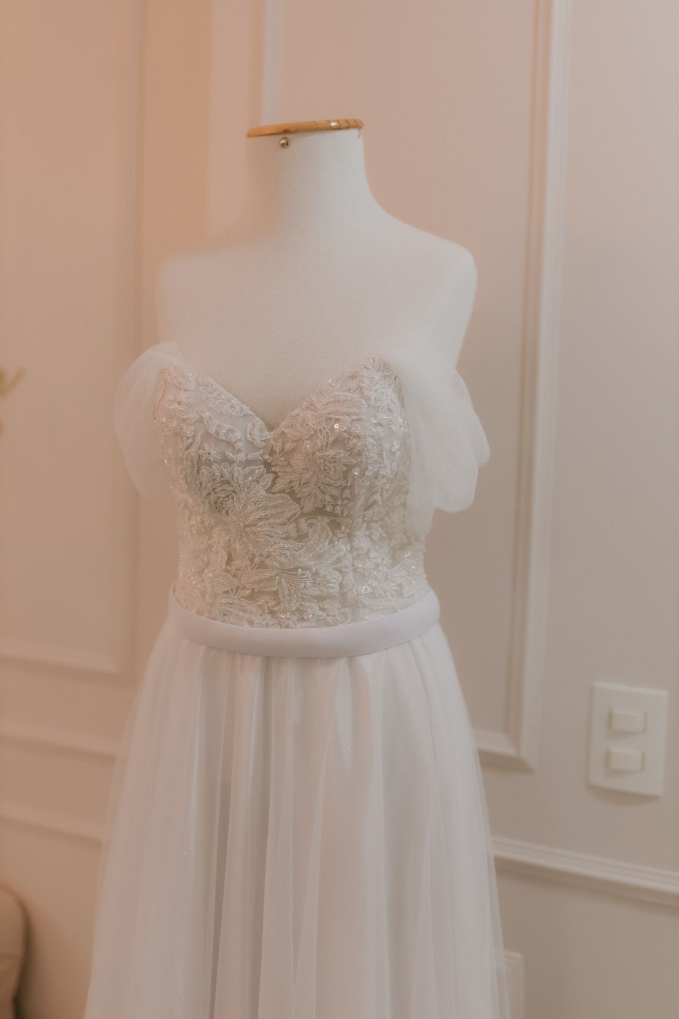 Representative photo of a lace bridal gown displayed on a dress form