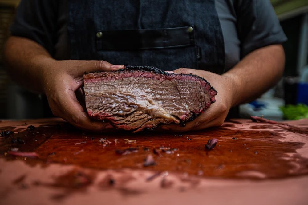 Close-up of sliced smoked brisket showing the pink smoke ring