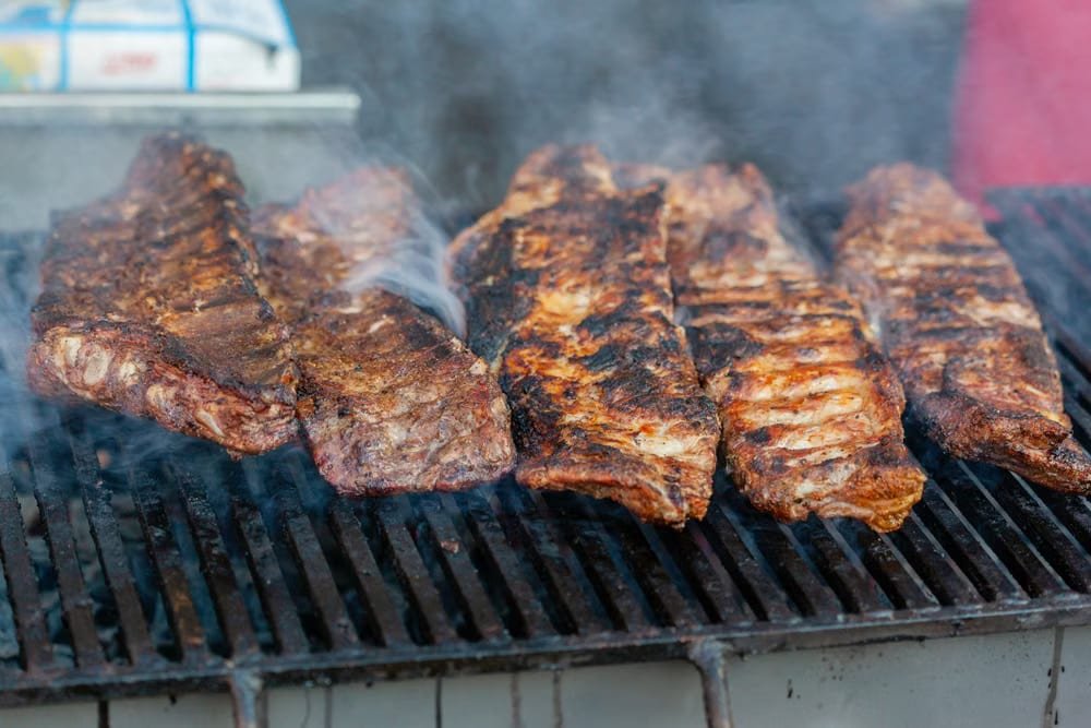 Baby back ribs with a dark smoked bark stacked and sliced