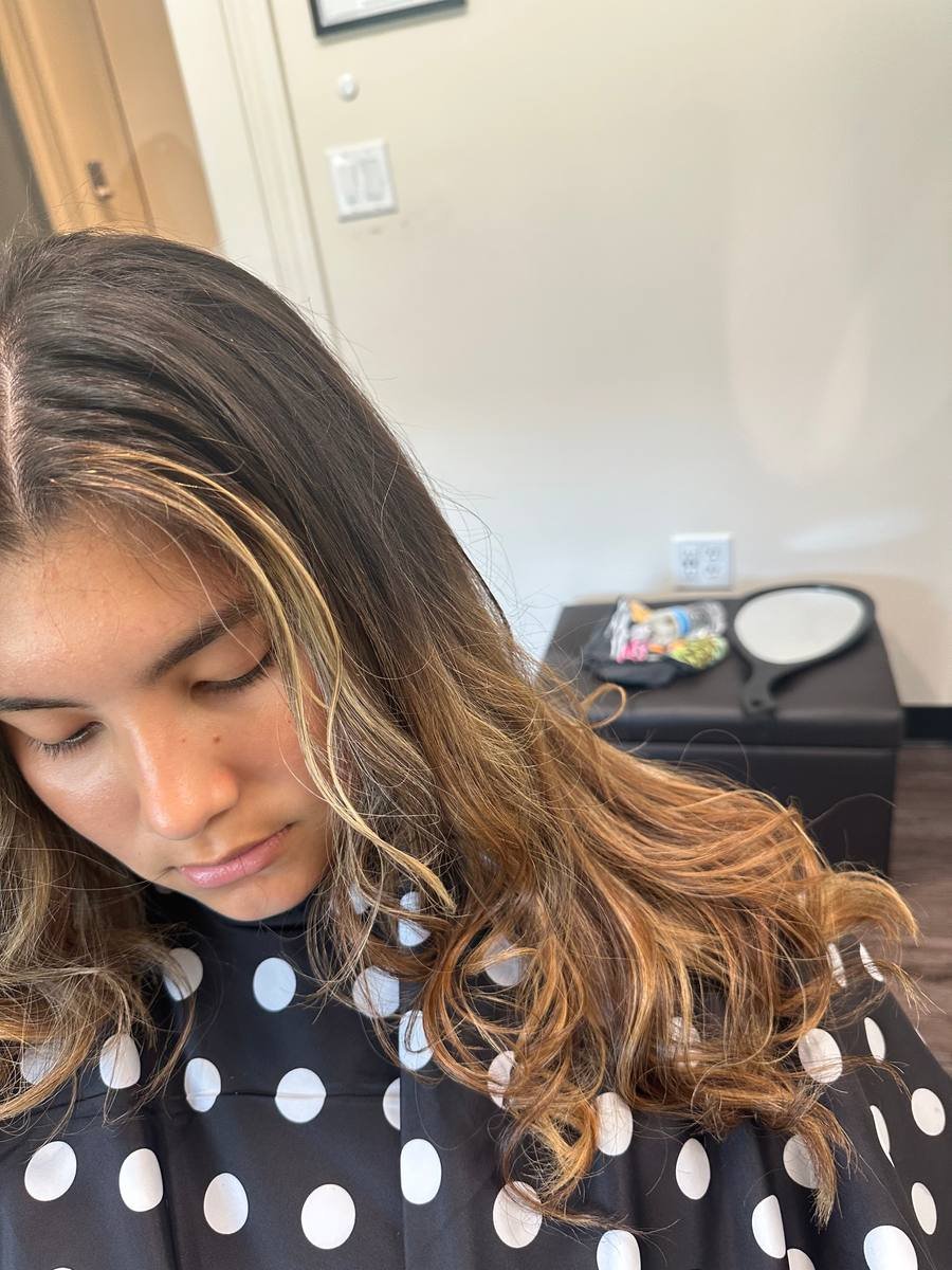 Sun-kissed balayage tousled into soft curls