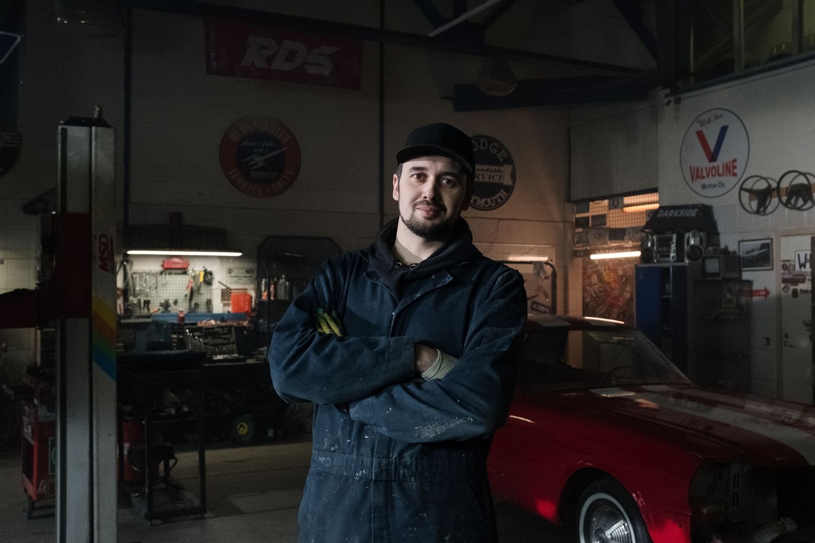 Representative photo of an automotive technician standing in a repair shop.