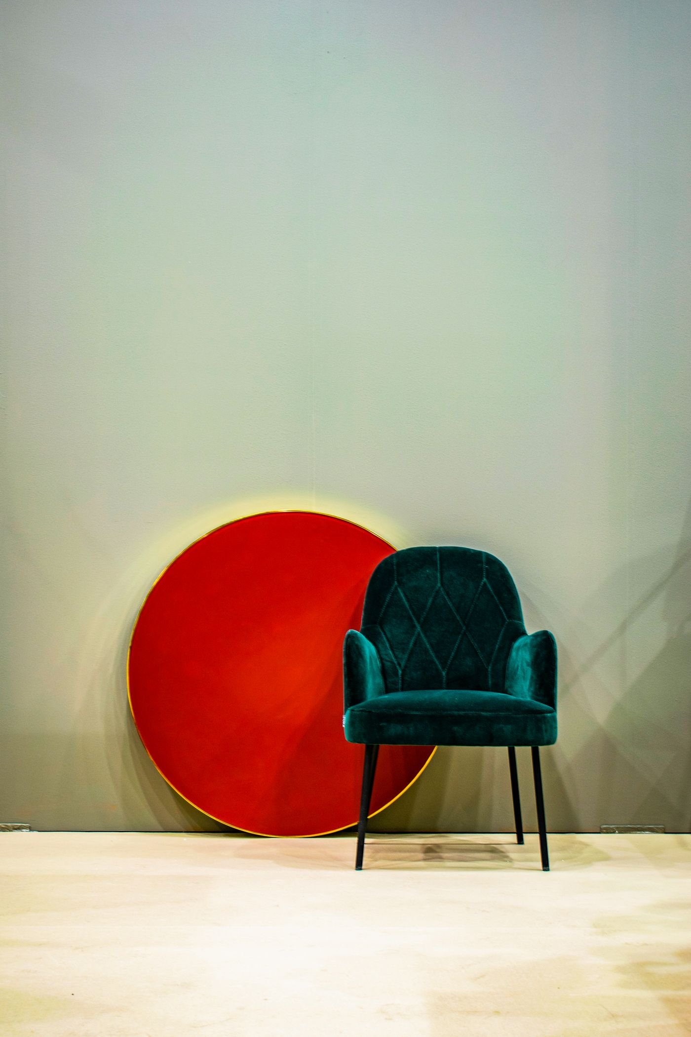 Representative photo of an armchair reupholstered in deep-green velvet, after restoration