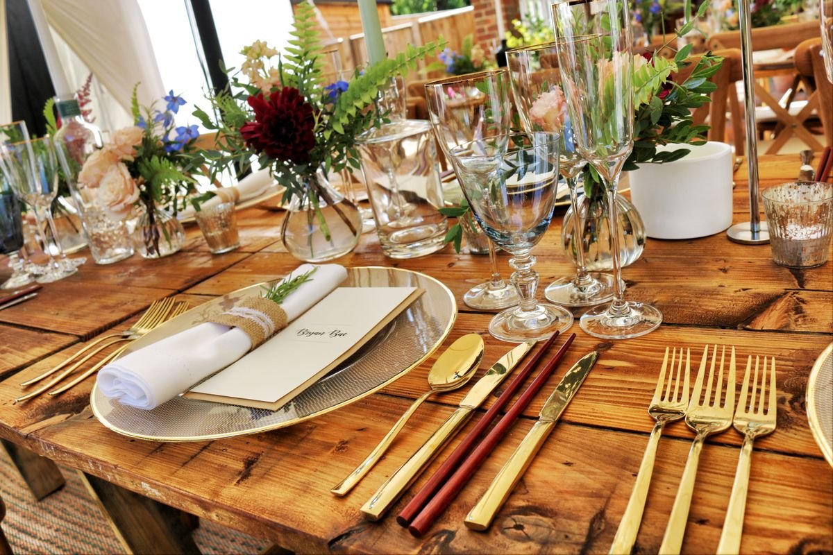 Representative photo: A place setting with gold chargers and flatware