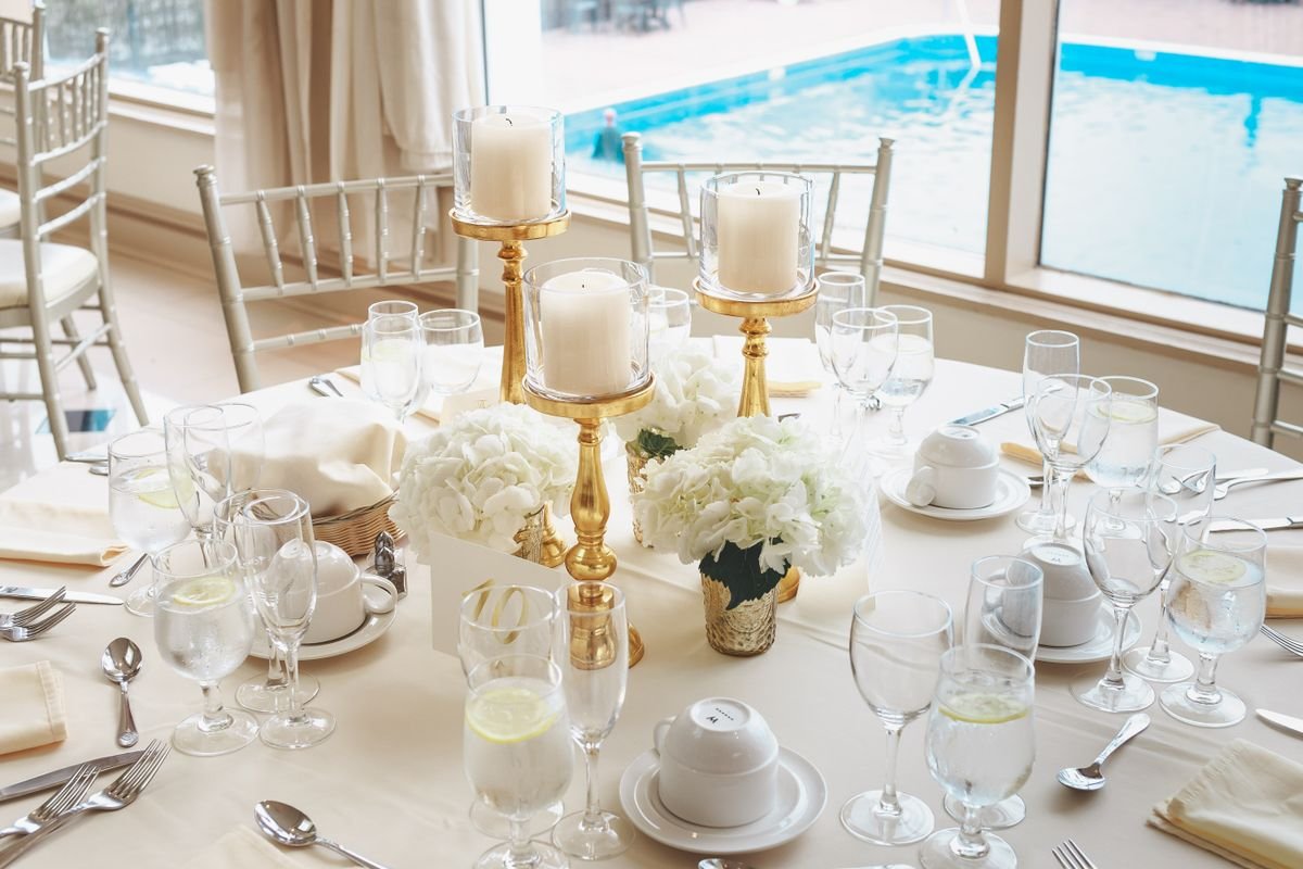 Representative photo: Table centerpiece with candles and white hydrangeas