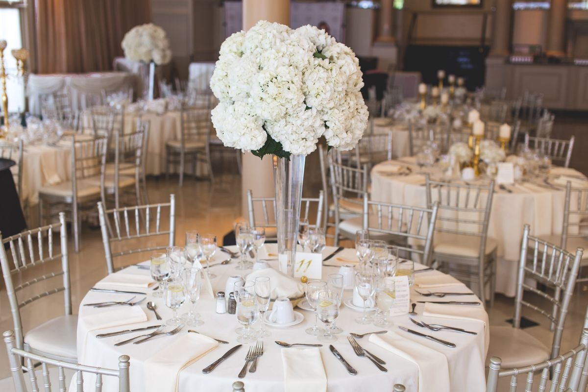 Representative photo: The main room set with tall floral centerpieces