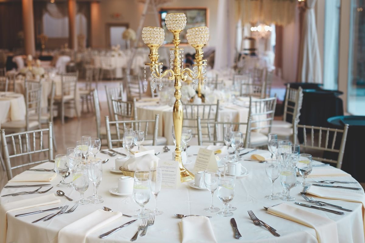 Representative photo of the banquet hall set with round tables and a crystal candelabra
