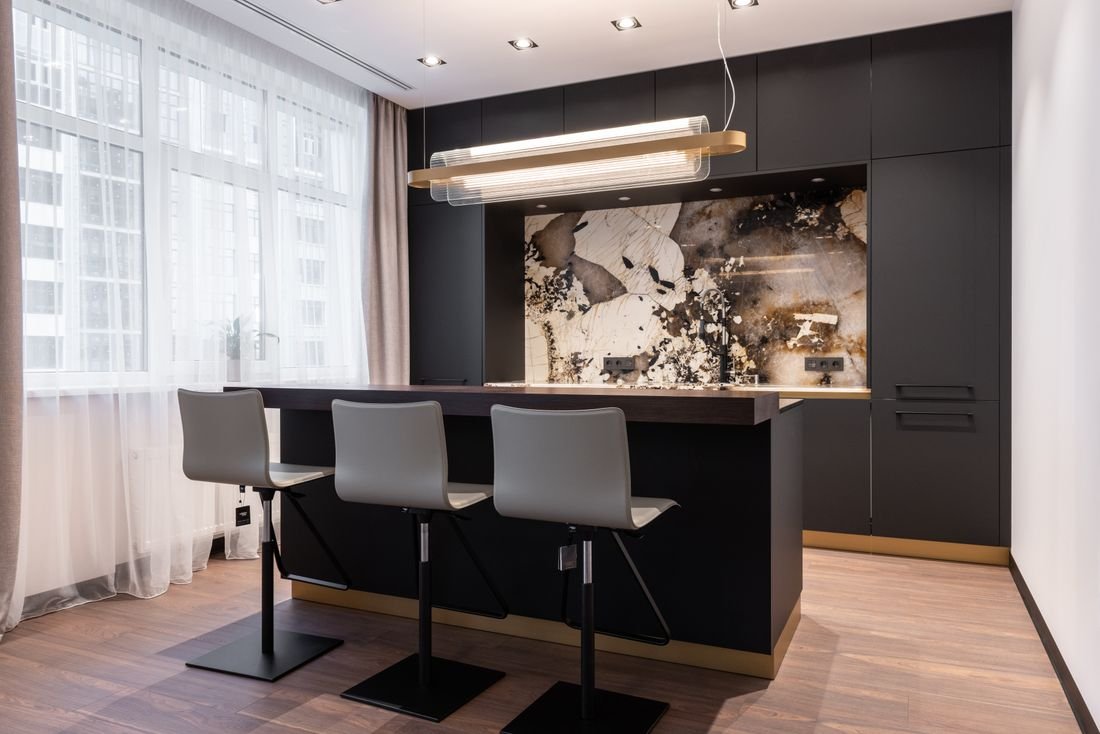 Dining area with floor-length sheer curtains and drapes by a bright window