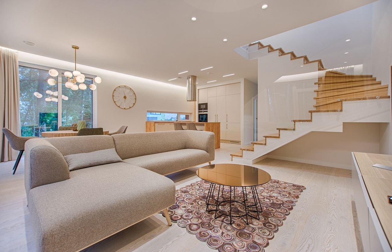 Open-plan living room with floor-length curtains framing tall windows