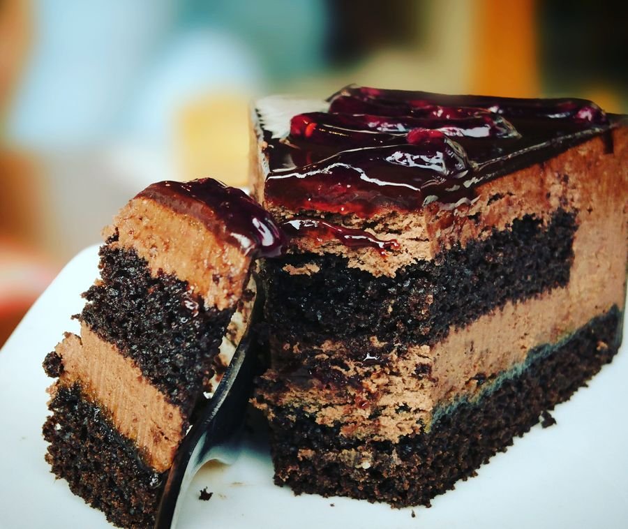 Slice of chocolate cake with berry glaze