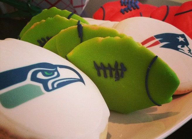 Hand-decorated shortbread cookies iced as footballs and team logos