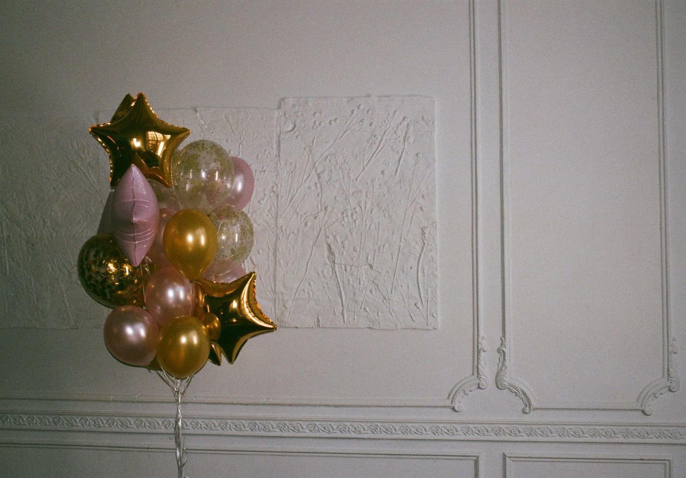 Representative photo of gold and pink foil star balloons.