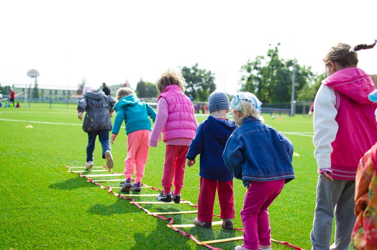 Representative photo of young children playing on an outdoor activity course