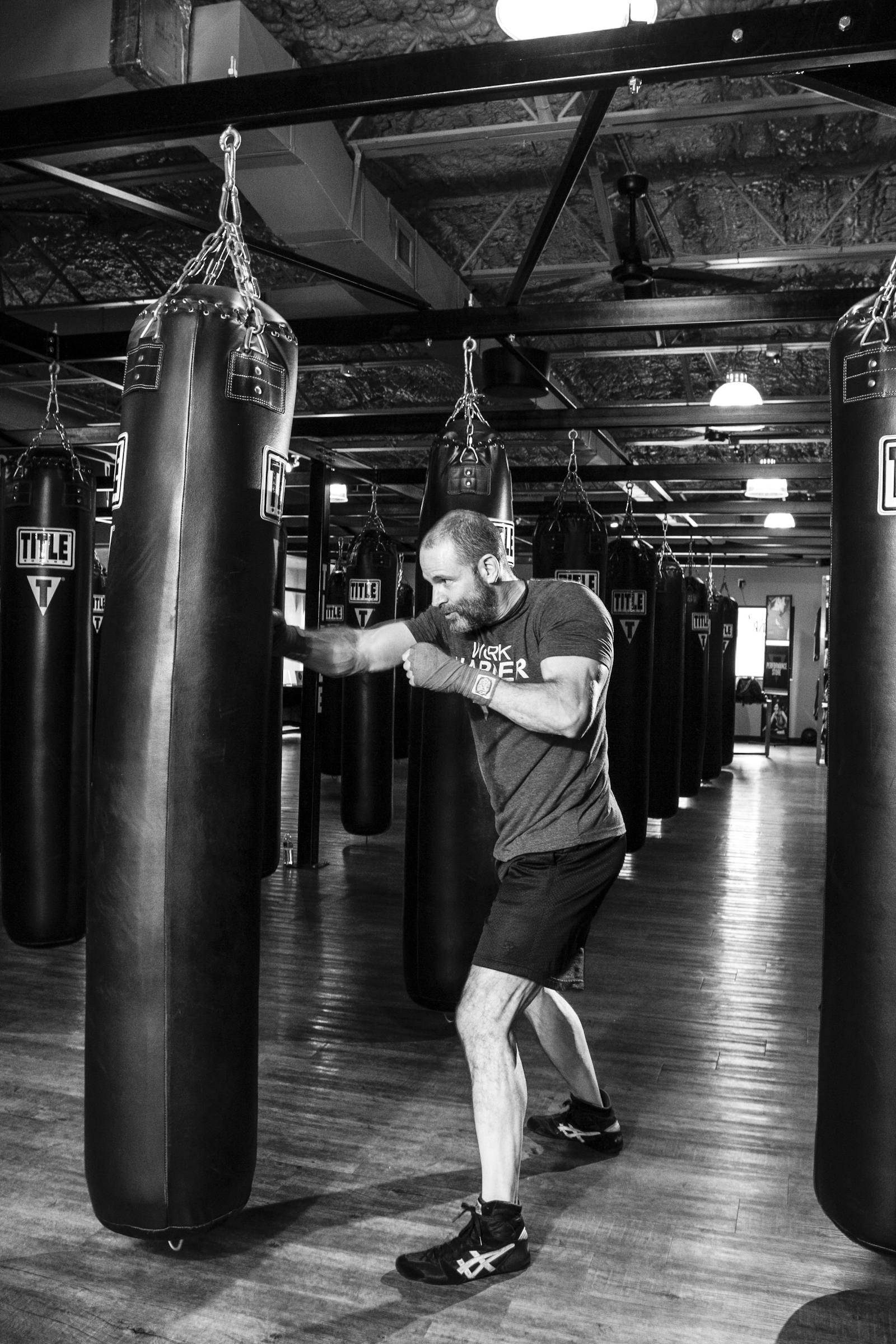 Black and white boxing training near a heavy bag