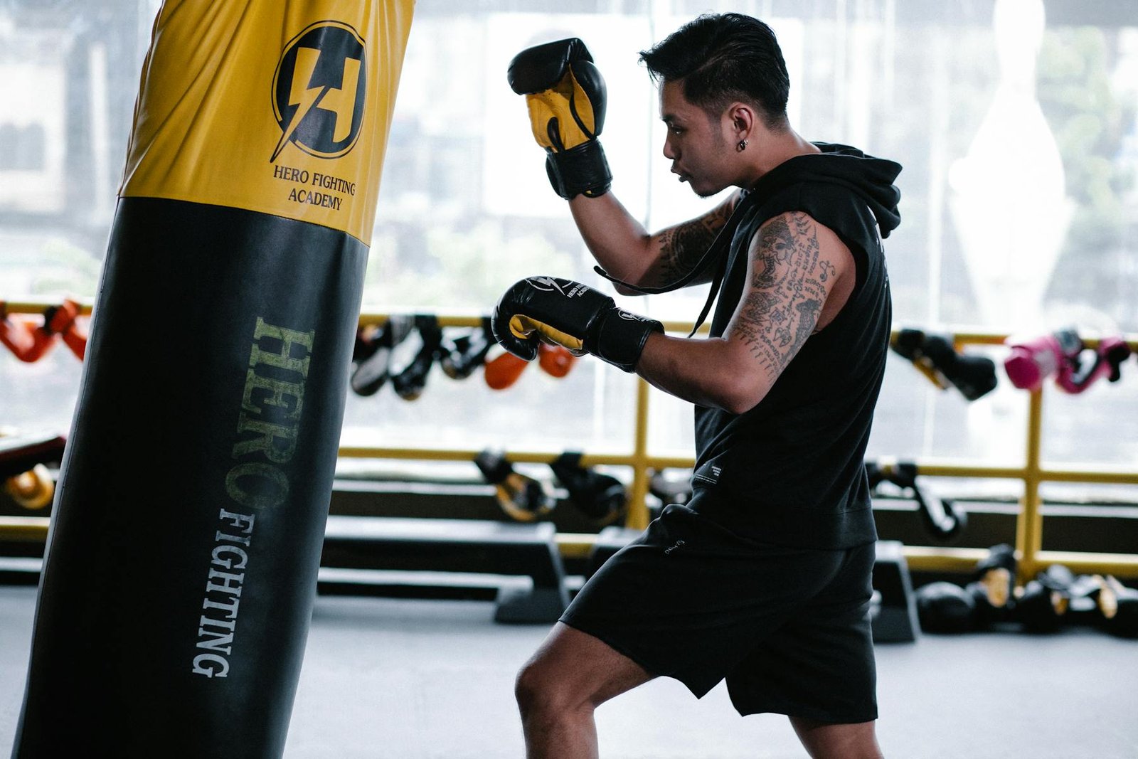 Real boxer training in a gym with a heavy bag