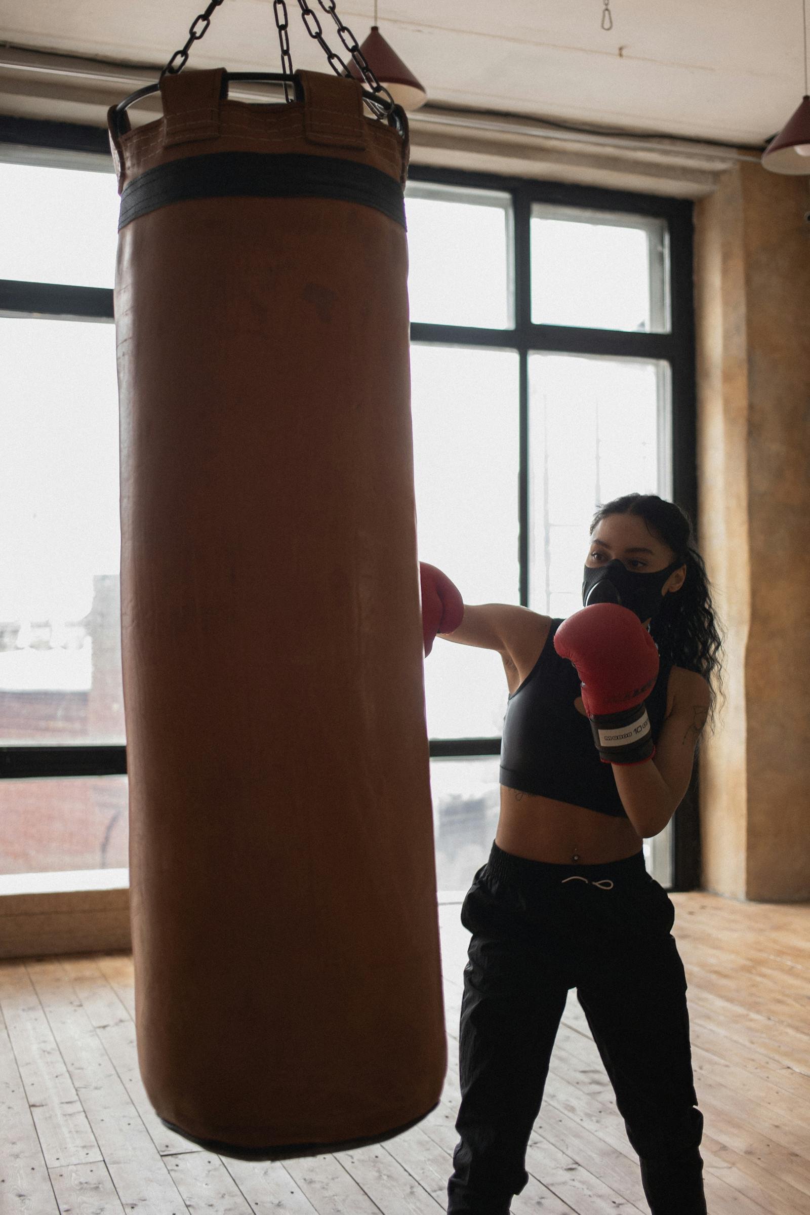 Athlete boxing on a heavy bag during conditioning