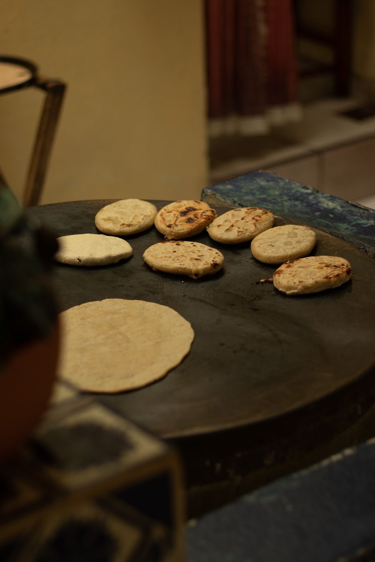 Representative photo of pupusas cooking on the comal