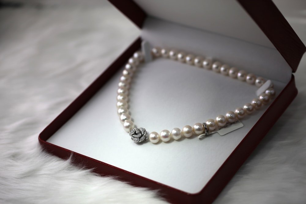 Representative photo of a pearl strand necklace in a box — client inventory swaps in
