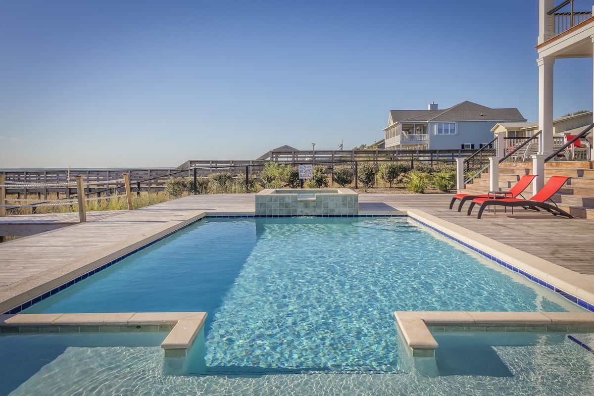 Representative photo of a sunlit backyard swimming pool with clean, balanced water