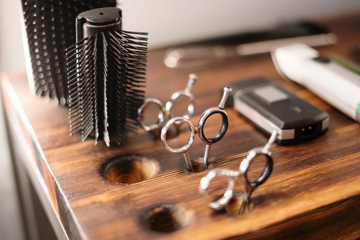 Representative photo of professional styling shears and a round brush
